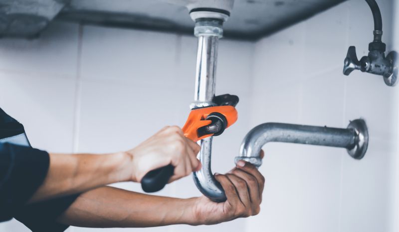 Plumber Using a Pipe Wrench